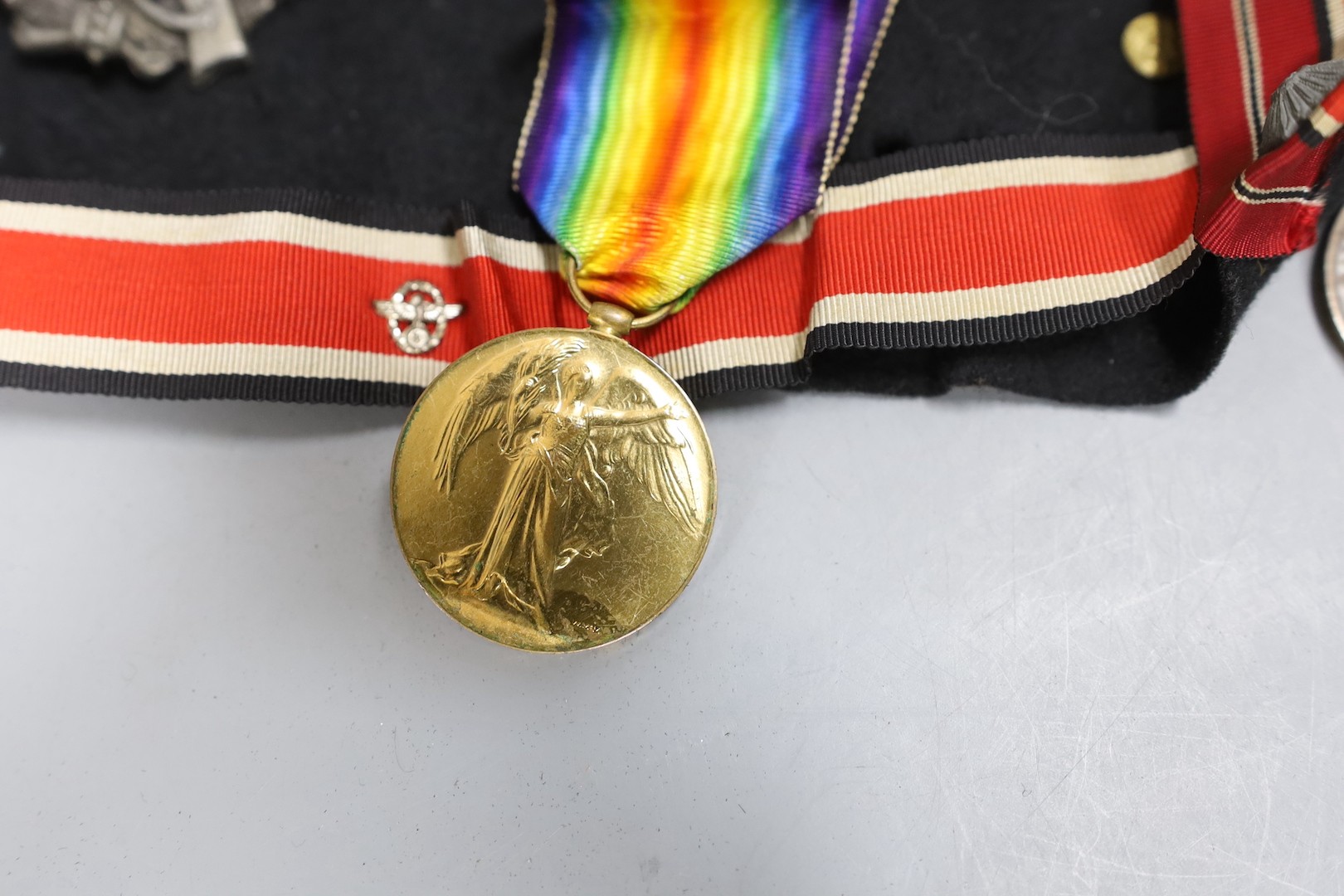 A group over WW1 to WW2 German medals and cap badges and a World War I pair to 2218924 PTE. 1. A. B. Ward. R.A.F. and two compasses